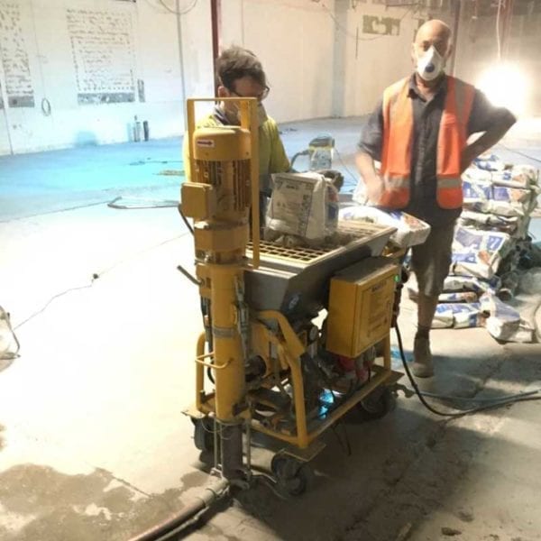 Yellow Continuous Grout Pump in use in a building site. Grout Pump Continuous Rental Perth