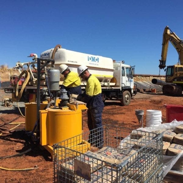 Twin Grout Pump & Mixer Pneumatic System being used on red dirt work site. These systems are available to hire via our Perth workshop.