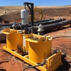 A rental Grout Pump & Mixer Pneumatic system on red dirt work site, alternative angle to view the other side of the grout pump system.