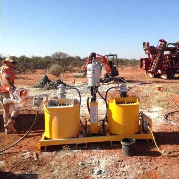 A rental Grout Pump & Mixer Pneumatic system on red dirt work site.