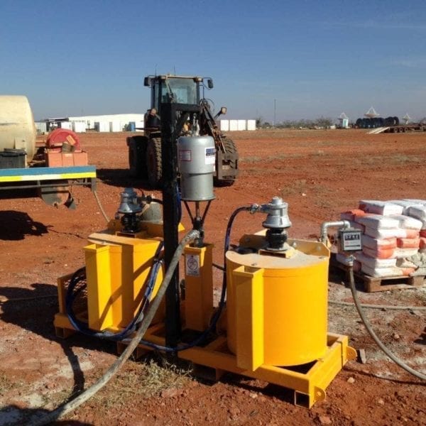 Grout Pump & Mixer Pneumatic on red dirt work site in preparations for work to commence. These pneumatic systems are available to hire via our Perth workshop.