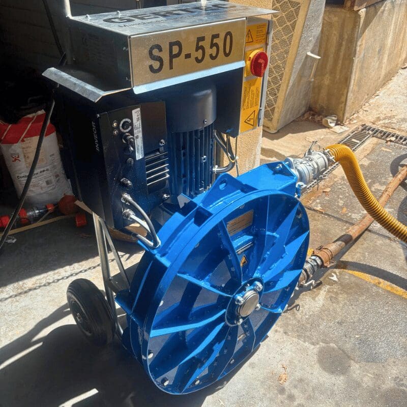 Peristaltic Grout Pump SP 550 sitting on concrete in front of the workshop.